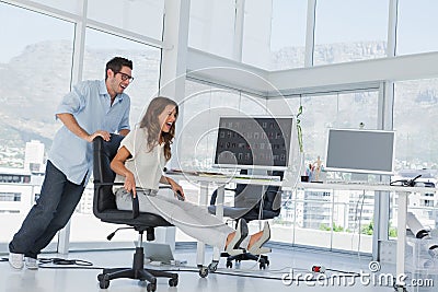 Designers having fun with a swivel chair Stock Photo