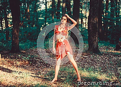 Desire. wild woman in forest. sexy girl in leather clothes. deep forest. cougar female. amazon woman. sexy witch. ethnic Stock Photo