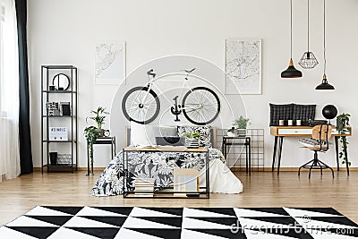 Desk and bicycle in bedroom Stock Photo