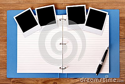 Photo album on wood table with several polaroid frame photo prints, copy space Stock Photo