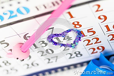 Desk calendar, pink pencil. 14 circled in red in the shape of a heart. Have a gift box Stock Photo