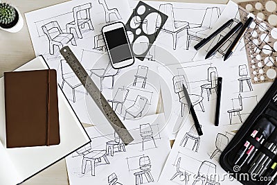 Desk with industrial designers sketches for chair concepts Stock Photo