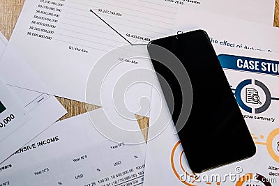 desk full of documents with reports and a lying black telephone Stock Photo