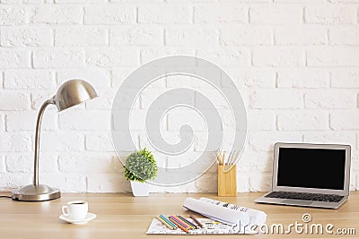 Desk with laptop and sketches Stock Photo