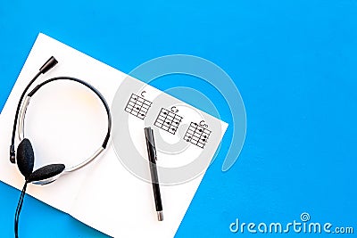 Desk of musician for songwriter work with headphones and notes blue background top view mockup Stock Photo