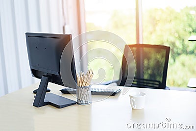 Desk in office with computer desktop pencils and coffee cup for designer desk - Table working place business office nature Stock Photo