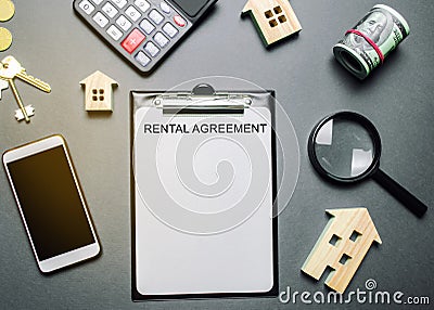 Desk real estate agent and tablet with the word Rental Agreement. The concept of a successful rental house or apartment. Property Stock Photo