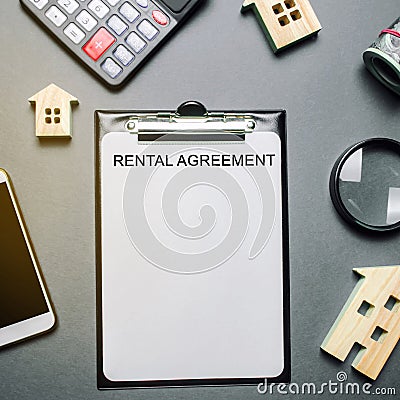 Desk real estate agent and tablet with the word Rental Agreement. The concept of a successful rental house or apartment. Property Stock Photo