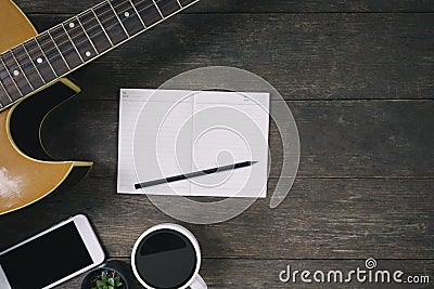 Desk of song composer for a work songwriter with a guitar. Stock Photo