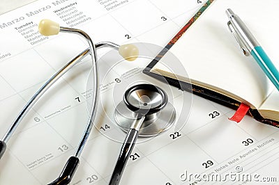 A desk top with stethoscope, notebook, pen and calendar. Stock Photo