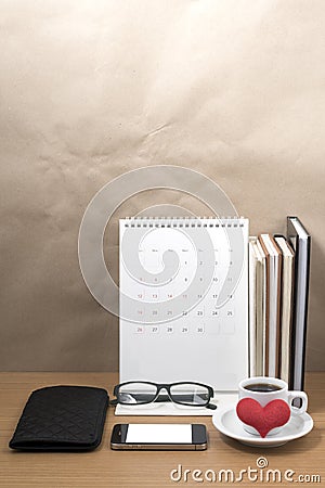 desktop : coffee with phone,stack of book,wallet,heart,eyeglasses,calendar Stock Photo