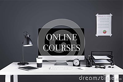 Desktop computer with online courses inscription on screen, business chart, clock and office supplies Stock Photo