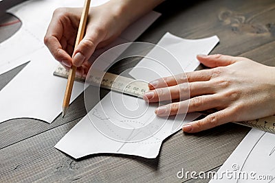 Desktop designer clothes with tools at wooden table Stock Photo