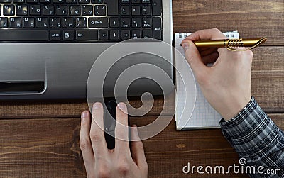 Desktop with laptop and hands top view Stock Photo