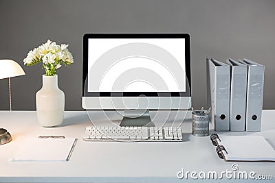 Desktop pc with flower vase and files Stock Photo