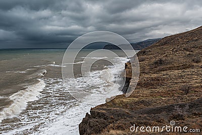 A desolate coast of a turbid stormy sea Stock Photo