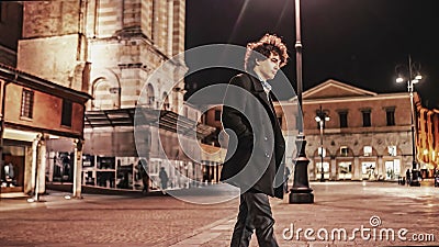 Desolate Night: Disheartened Young Man Looking Around in the City Stock Photo