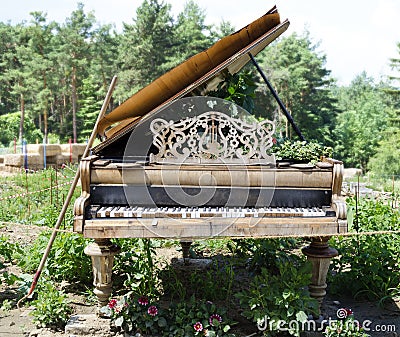 Desolate piano at a garden Stock Photo
