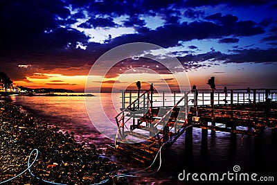 Desolated Dock On Sunset With Calm Sea Stock Photo