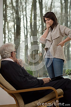 Despair woman talking with therapist Stock Photo