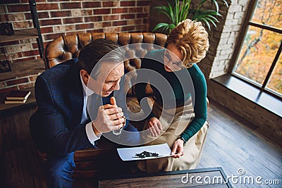 Despaired middle aged man looking at image Stock Photo