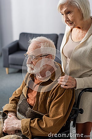 Despaired senior woman touching shouder of Stock Photo