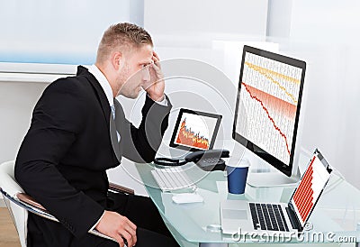 Despairing businessman faced with financial losses Stock Photo