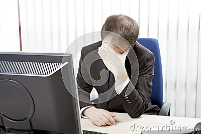 Despairing businessman at his desk Stock Photo