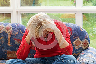 Desperate blonde middle-aged woman Stock Photo