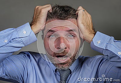 Desperate businessman in shirt and necktie suffering crisis screaming crazy feeling tired and overwhelmed isolated on studio Stock Photo