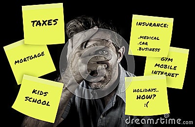 Desperate and frustrated family man covering eyes scared after domestic accounting worried about money and taxes calculating expen Stock Photo