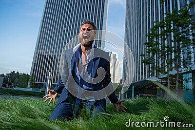 Desperate man crying during bad business. Angry businessman having bad work results. Stressed business man outdoor. Stock Photo