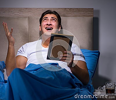 Desperate man divorced in bed Stock Photo