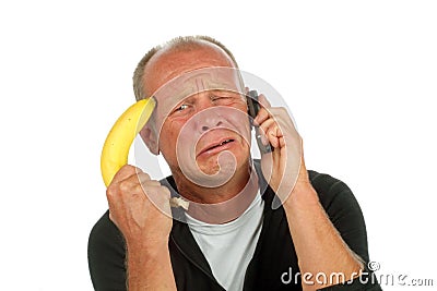 Desperate man phoning with banana gun Stock Photo