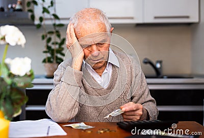 Desperate old man pensioner counting his last money Stock Photo