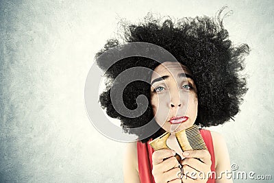 Desperate woman can't comb her hair because she broke her comb Stock Photo