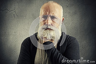 Despondent senior man over grey backround Stock Photo