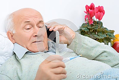 Despondent weary aged man calls up his relatives Stock Photo