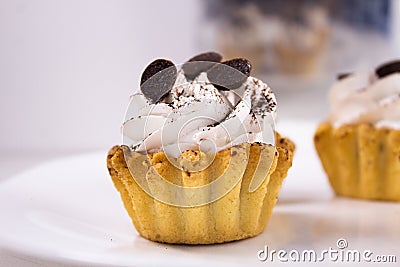 Dessert basket with white cream and cocoa topping. Close up Stock Photo