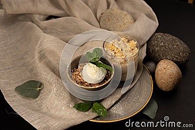 Dessert granola with a scoop of vanilla ice cream decorated with mint leaves. Stock Photo