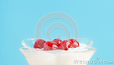 A dessert with maraschino cherry in a glass. Whipped cream, greek yogurt, ice cream. Close up Stock Photo