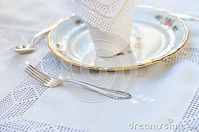 Dessert set: porcelain plates with silver cutery and lace napkin Stock Photo