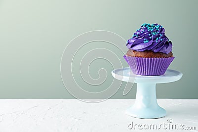 Dessert stand with tasty cupcake on white table Stock Photo