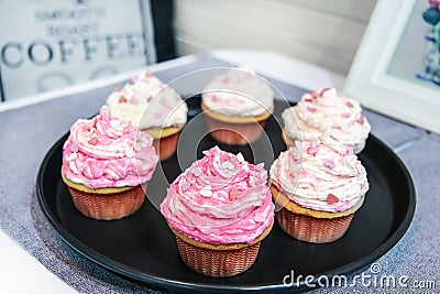 Dessert Valentine vanilla cupcakes with pink and white cream decorated with sweet hearts Stock Photo