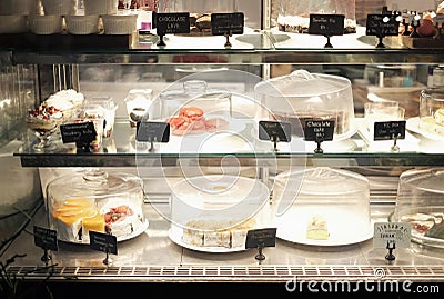 Desserts on sell with names and prices in bakery shop Stock Photo