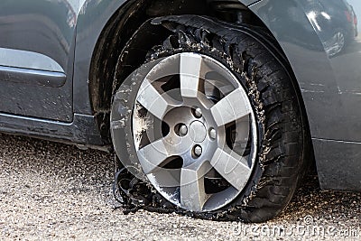 Blown out tire with exploded, shredded and damaged rubber Stock Photo