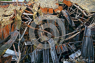 Destroyed industrial building. Insulated roof structures of an industrial building after fire and collapsing Stock Photo