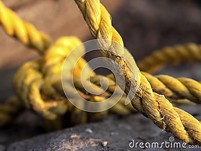 Destroyed light concrete slabs, tied with a thick yellow rope, cable. construction and replacement concept Stock Photo