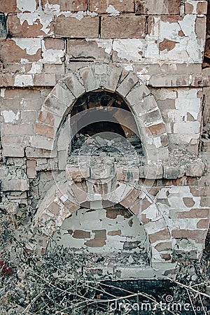 Destroyed old brick home stove concept photo. Damaged vintage oven on backyard. Stock Photo