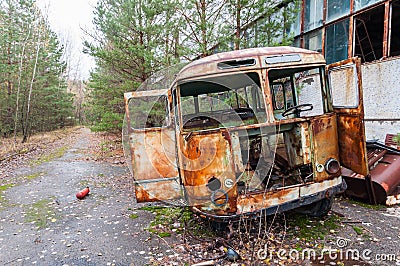 Destroyed old rusty bus at Factory in Pripyat ghost city, Chernobyl Nuclear Power Plant Zone of exclusion and alienation Stock Photo